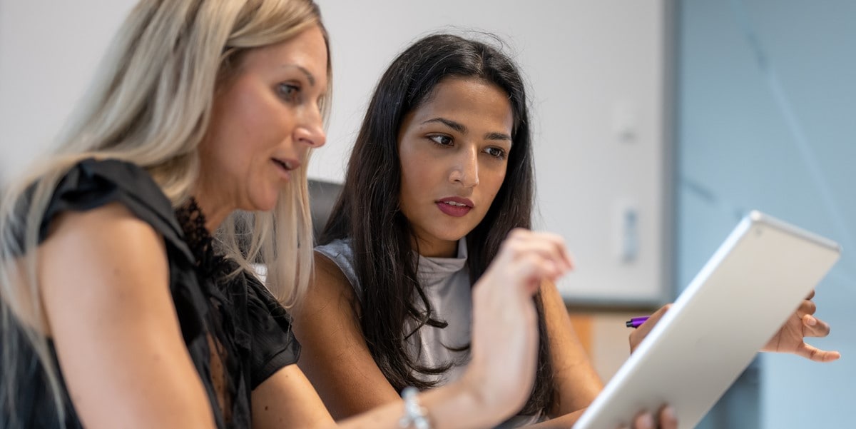 two professionals reviewing documents in office