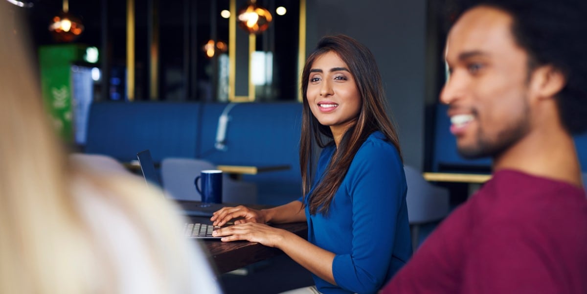 two professionals in office meeting, sitting on couch