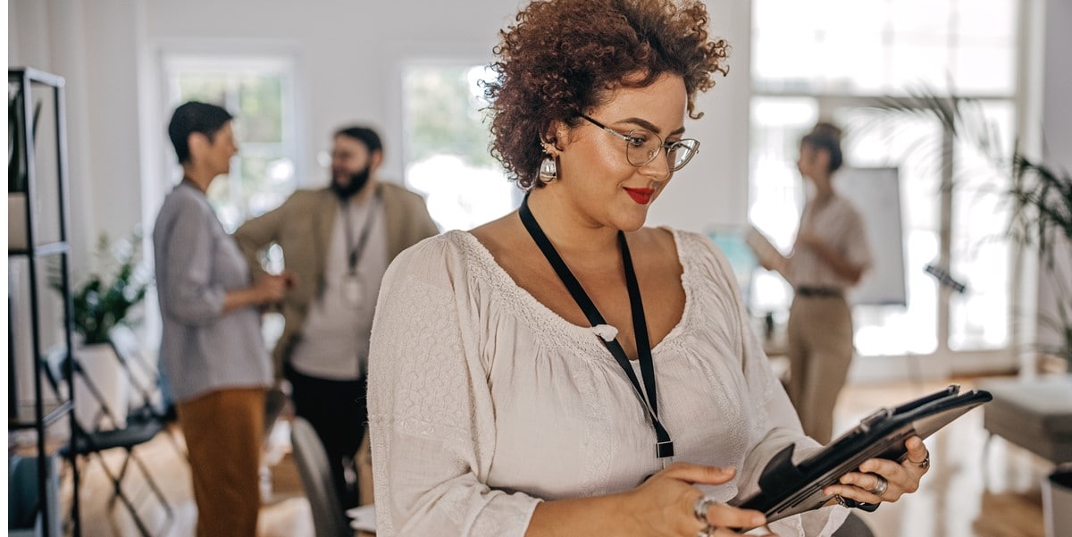 professional woman in office holding tablet