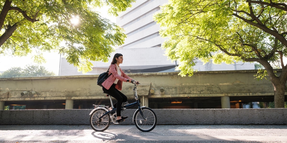 woman riding bicycle through city