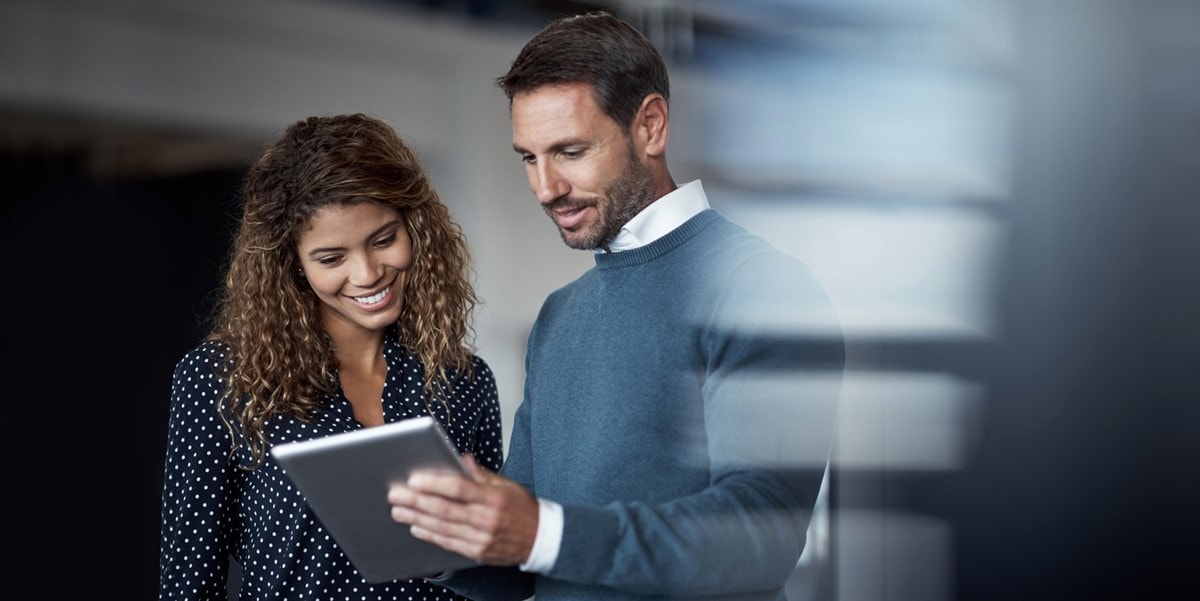 two professionals reviewing document, in the office