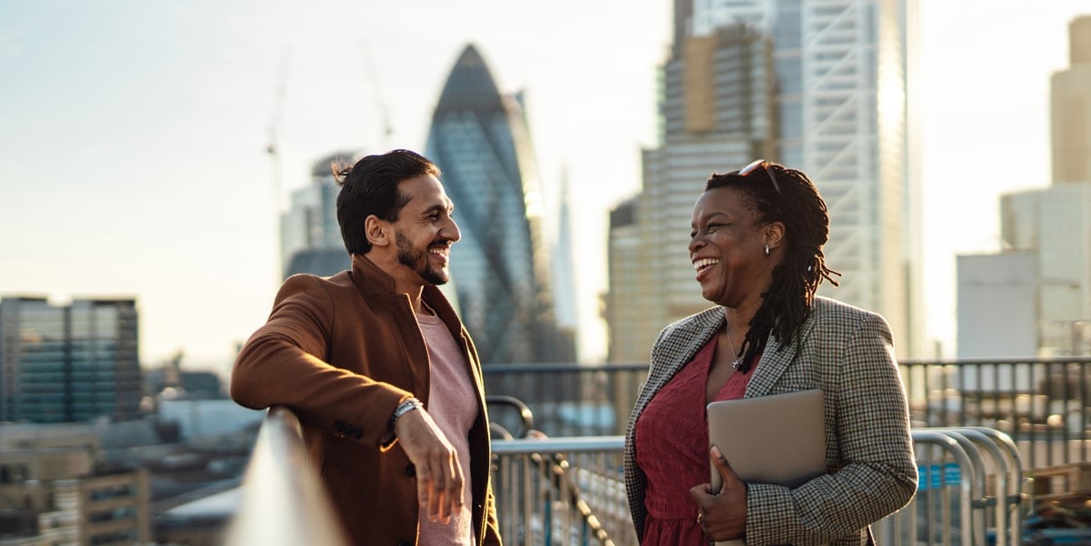 two people speaking, outdoors