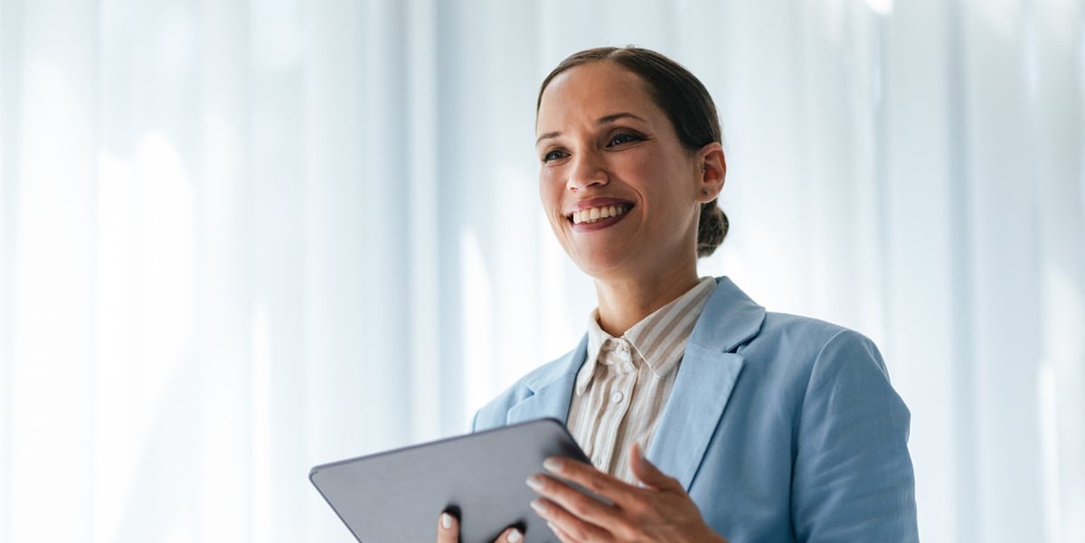 professional woman in office holding tablet